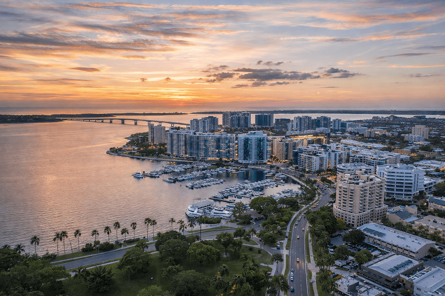 Sarasota waterfront skyline at sunset with marina and city buildings
