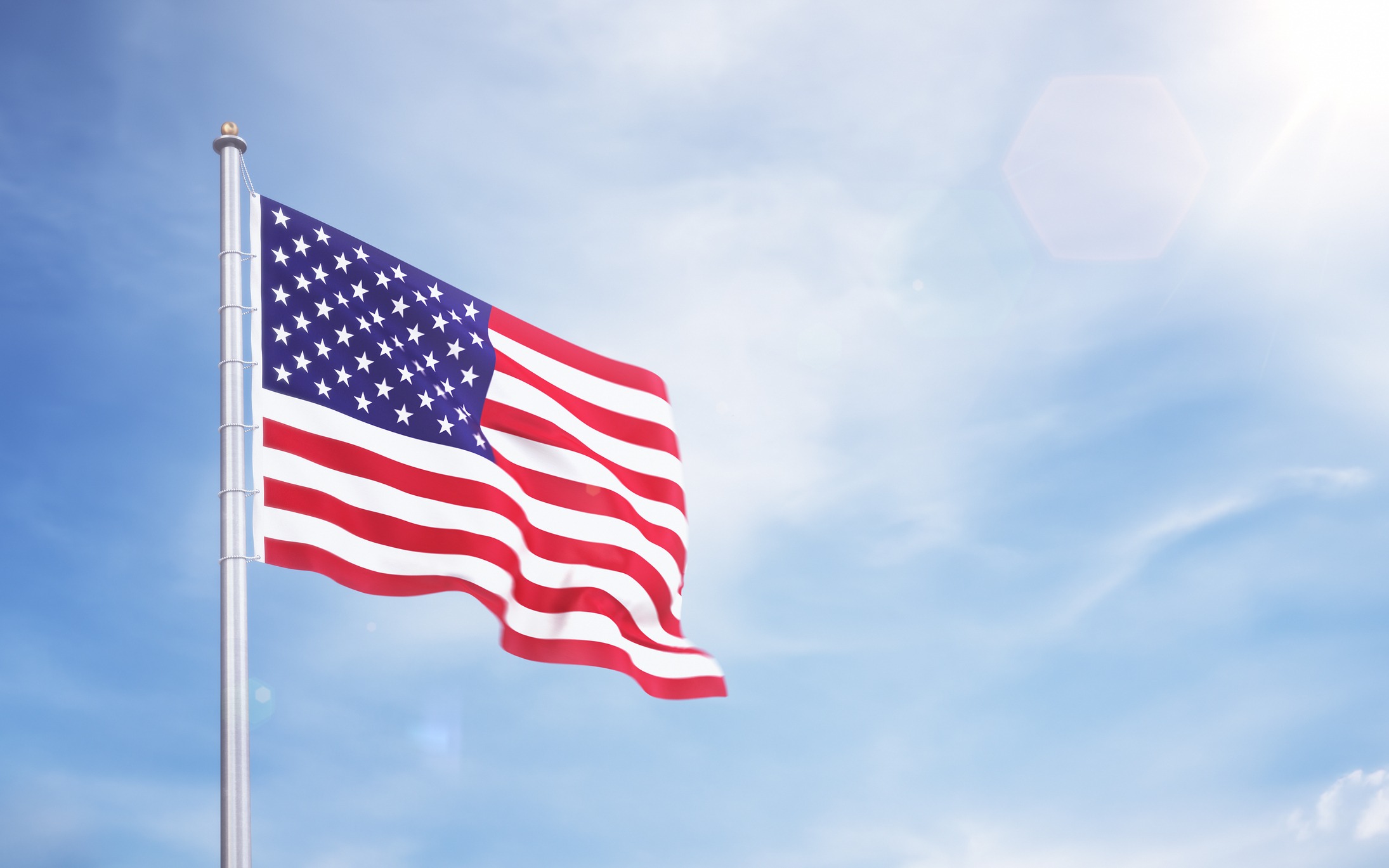 American flag waving against a clear sky